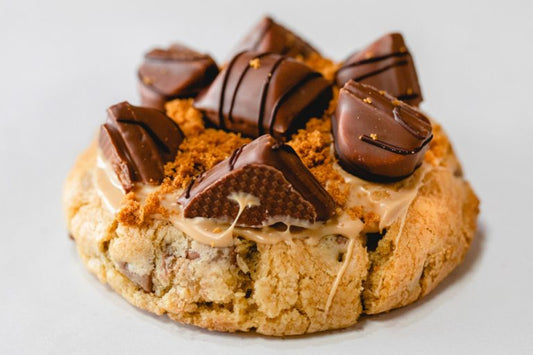 FAT Cookie: "Bueno’s Dias" Loaded with Caramel Fudge pieces, Caramilk & Shortbread.  Topped with Twix & Dulce de Leche sauce.