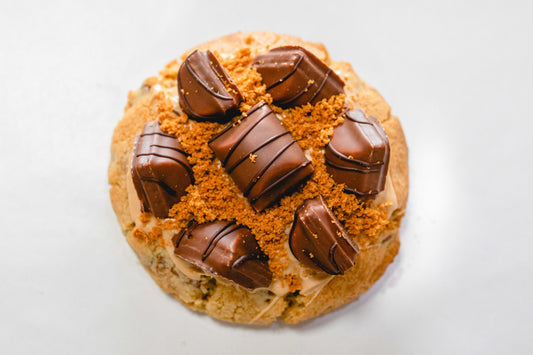 FAT Cookie: "Bueno’s Dias" Loaded with Caramel Fudge pieces, Caramilk & Shortbread.  Topped with Twix & Dulce de Leche sauce.